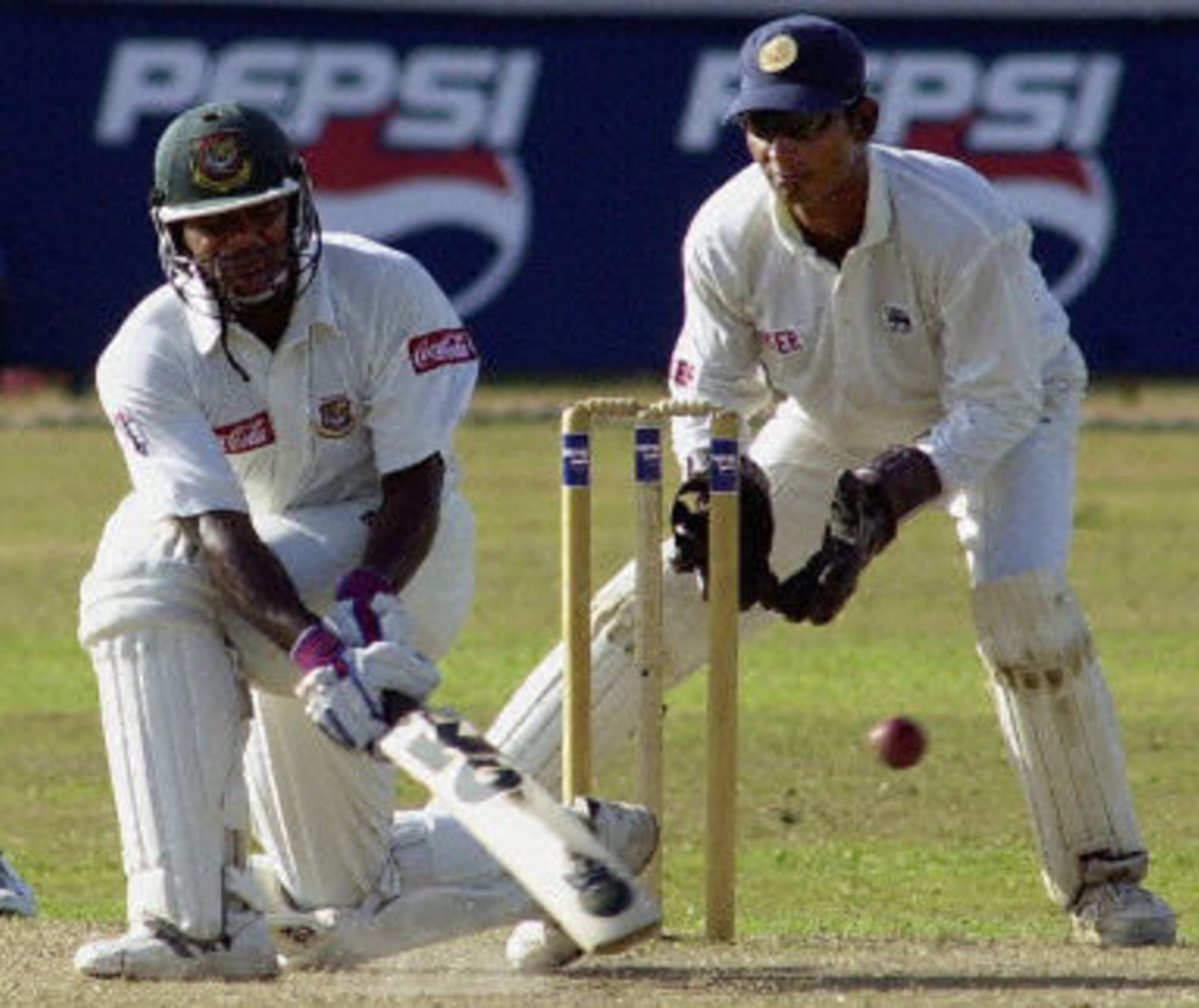 Bangladeshi Batsman Aminul Islam Sweeps A Ball As Sangakkara Looks On