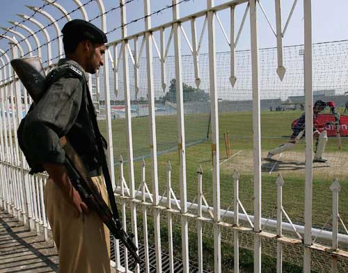 An Armed Guard Watches Michael Vaughan Bat During A Training Session