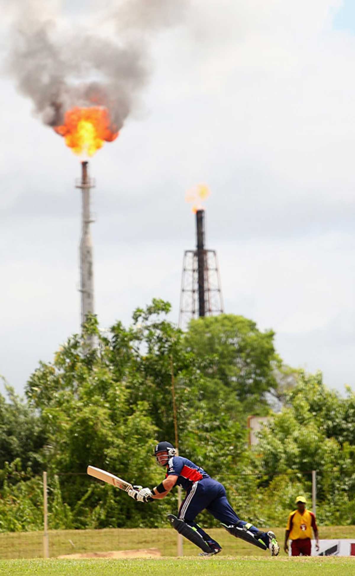 Ian Bell is pictured in front of a large oil refinery at Guaracara Park, Trinidad, March 14, 2009