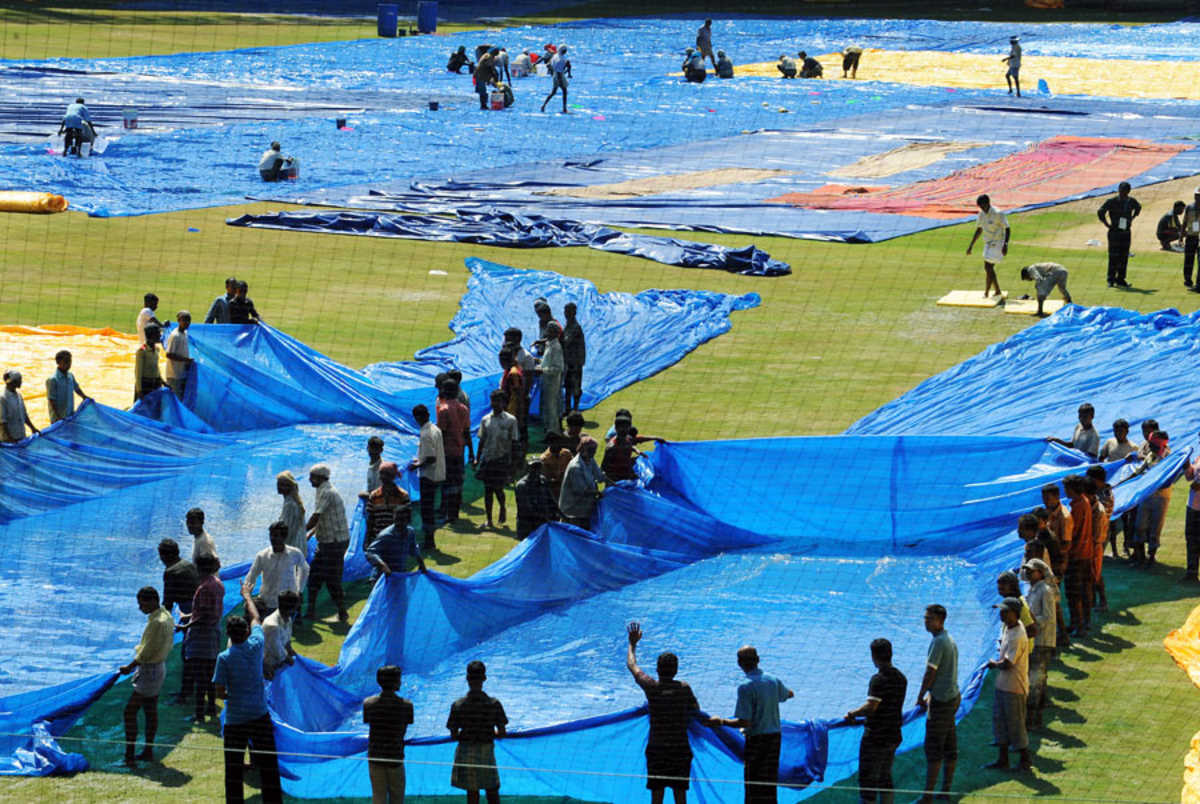 Groundstaff trying to dry the outfield in Kochi