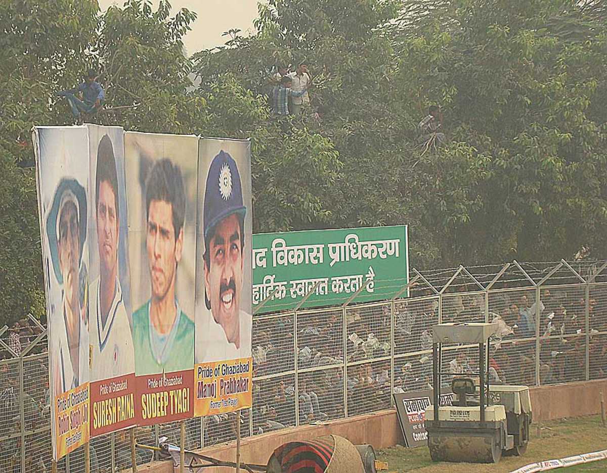 People watch the action in Ghaziabad from the trees