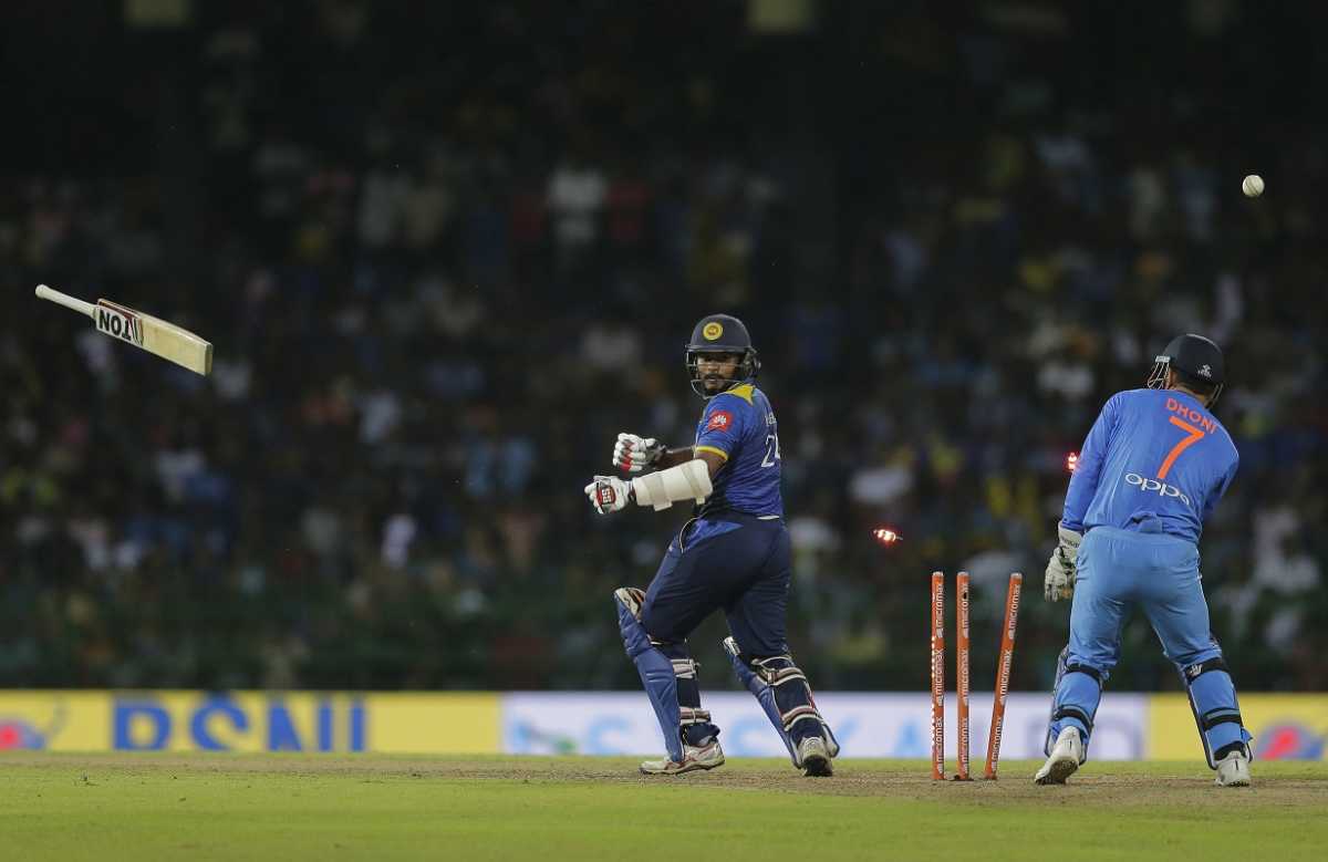 Sri Lanka's Dilshan Munaweera leaves the field after dismissal