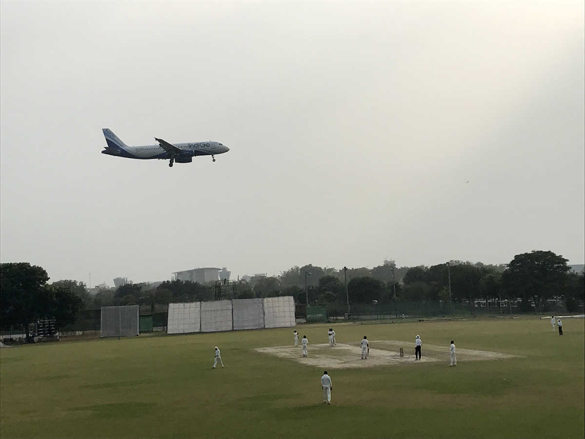 An aircraft flies over the Palam ground in Delhi, during the Delhi v Maharashtra Ranji Trophy game
