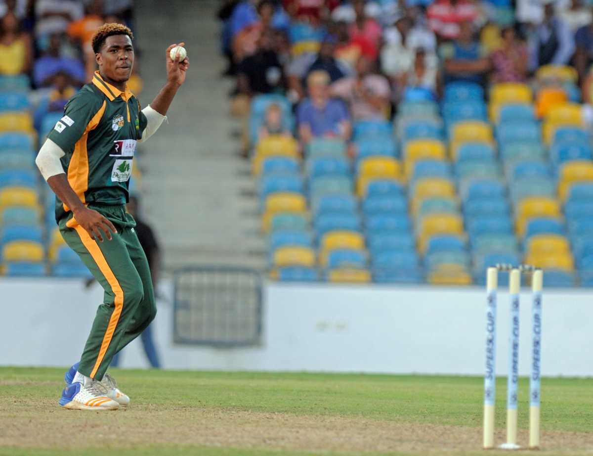 Obed McCoy shapes to throw the ball at the stumps