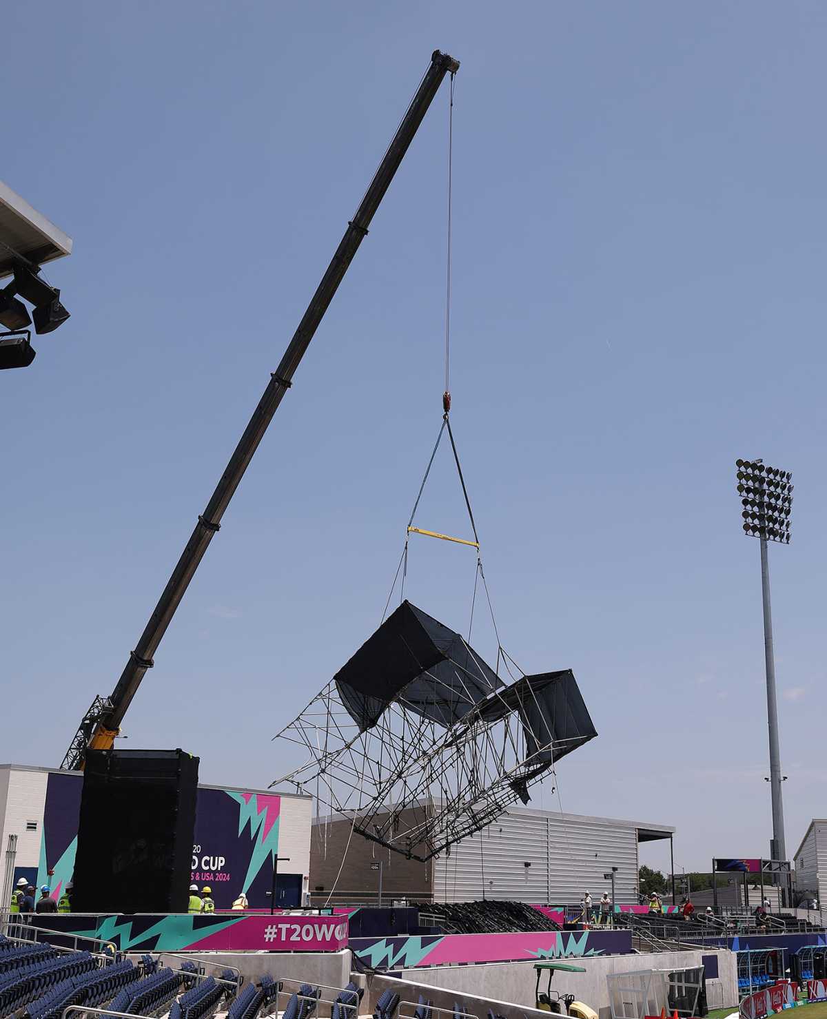 A crane removes a structure damaged by storms in Dallas, Grand Prairie Cricket Stadium, Dallas, May 29, 2024
