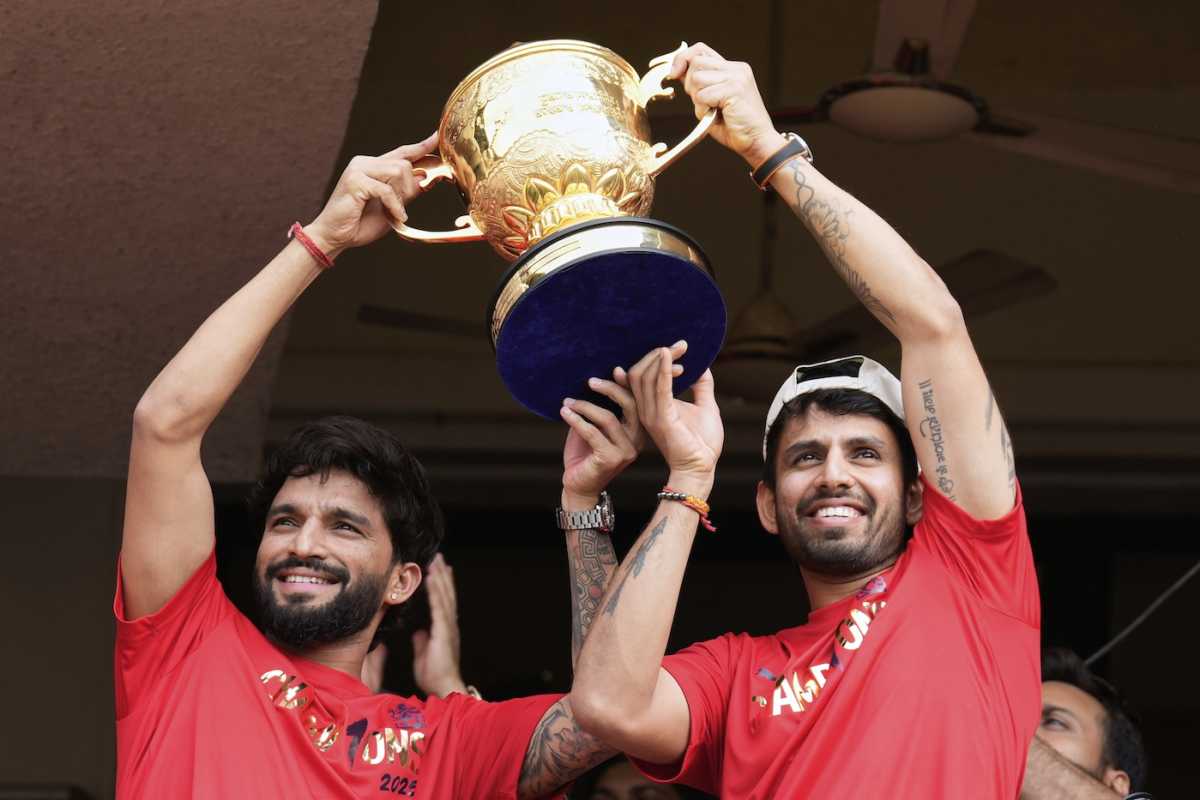 Rajat Patidar and Jitesh Sharma hold the IPL trophy up for the fans, Bengaluru, June 4, 2025