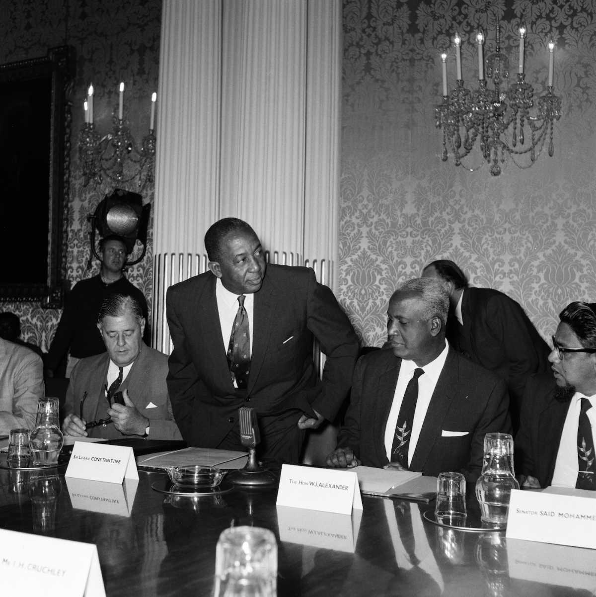 Sir Learie Constantine, Commissioner for the Trinidad and Tobago Government Office taking his seat at a conference, London, May 28, 1962 