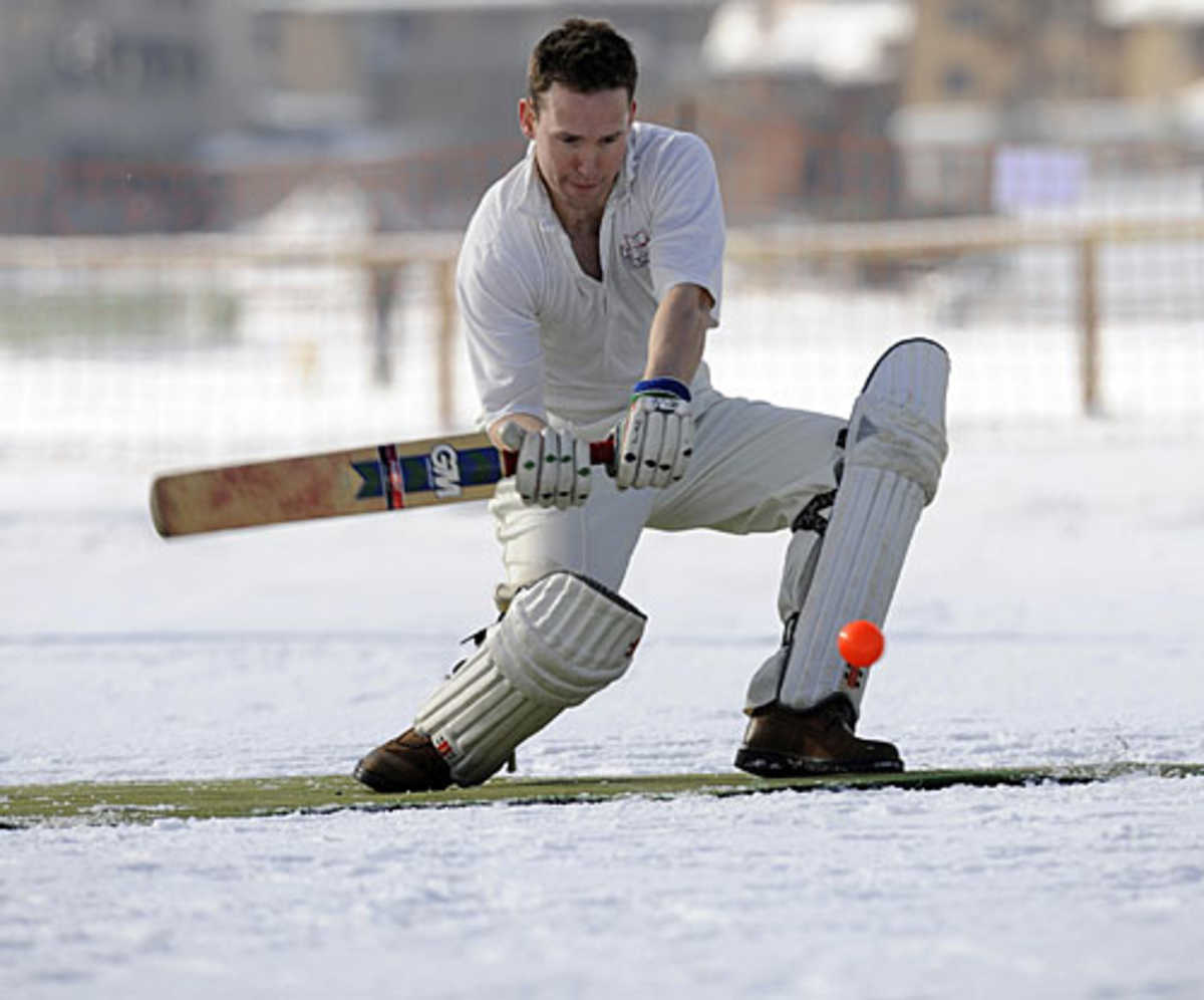A player waits to drive the ball in to the snow