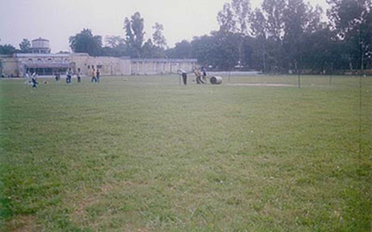 The groundsmen at work on the pitch at the Railway Stadium, Moradabad, Uttar Pradesh