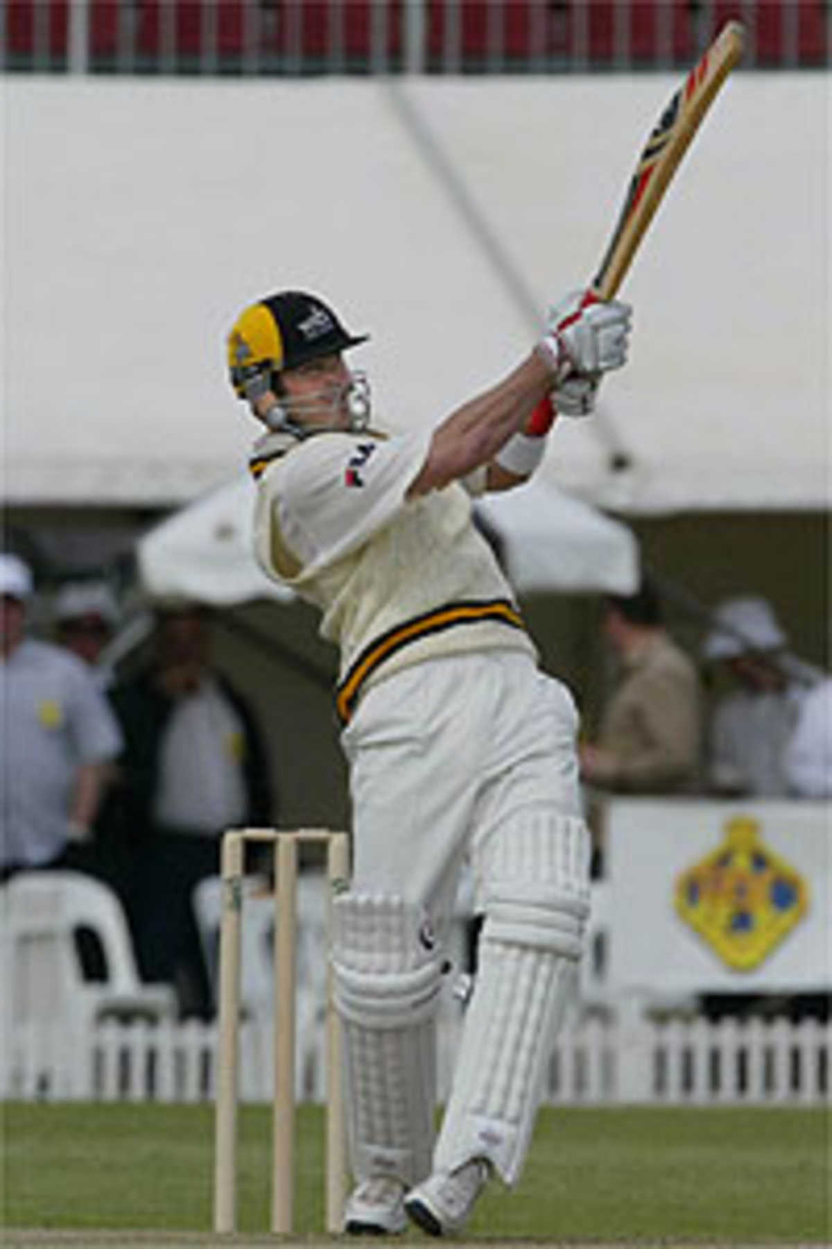 Australian batsman Damien Martyn bats over Sean Ervine of Zimbabwe during the Australian Cricket Board Chairman's X1 at Lilac Hill in Perth, 01 October 2003.