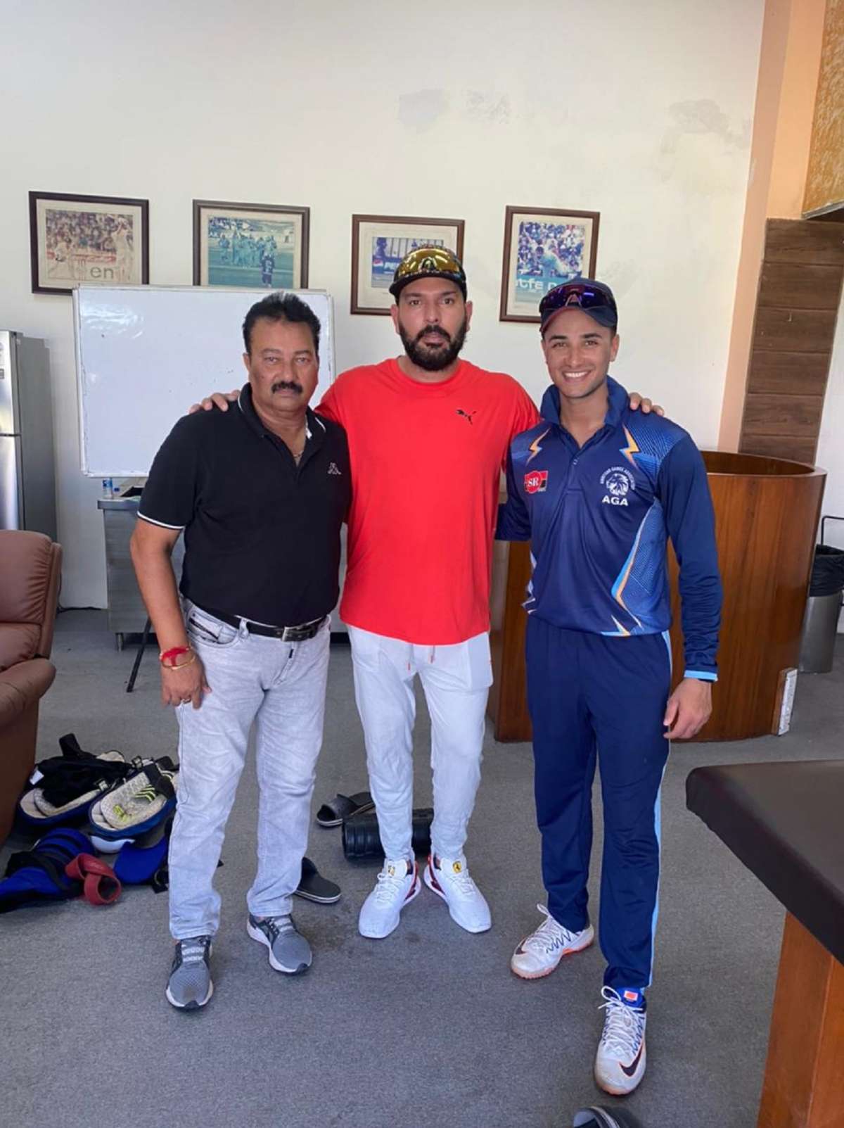 Punjab's Abhishek Sharma with his father Raj Kumar and Yuvraj Singh