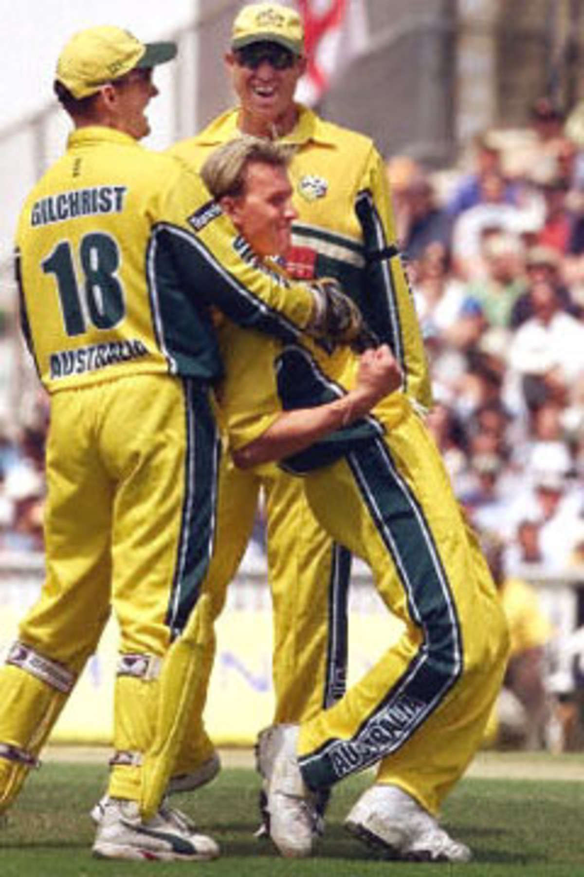 Brett Lee is hugged by Adam Gilchrist and Matthew Hayden after