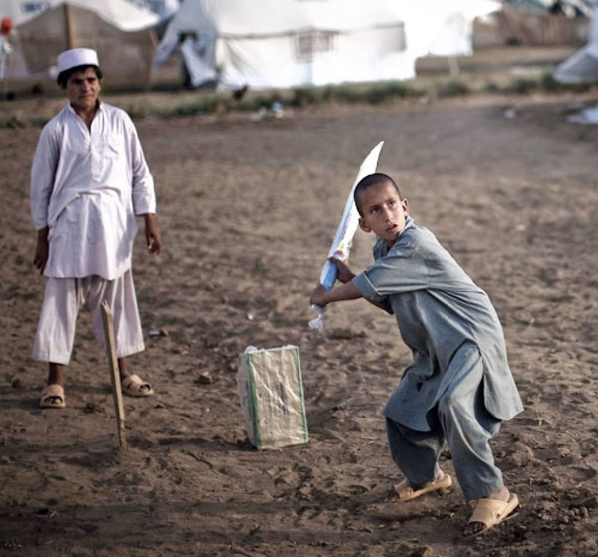 Homeless children play cricket after being displaced by the Taliban, Swabi, Pakistan, May 19, 2009
