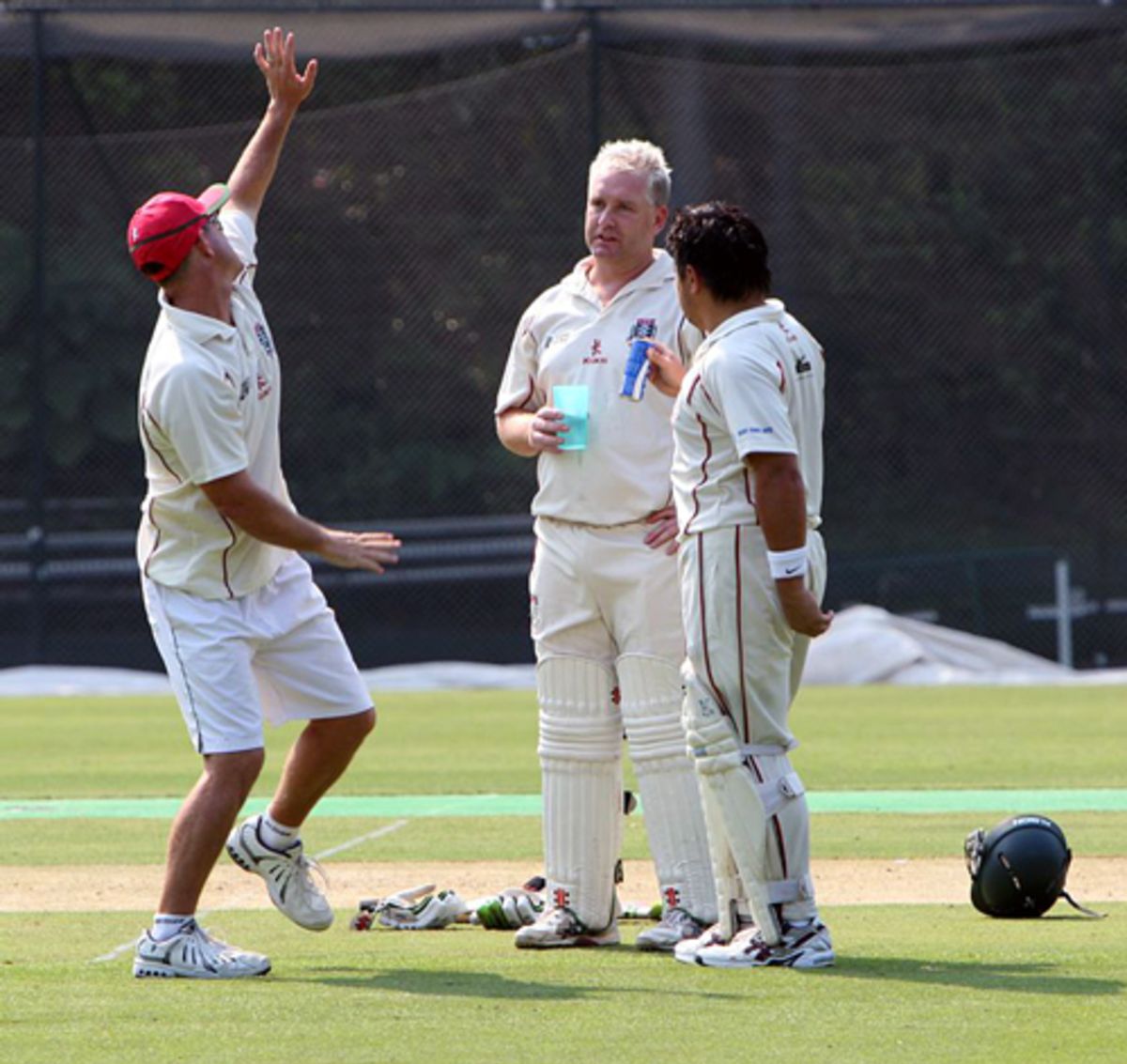 Todd Johnsen entertains Damian Kelleher and Roy Lamsam during a drinks