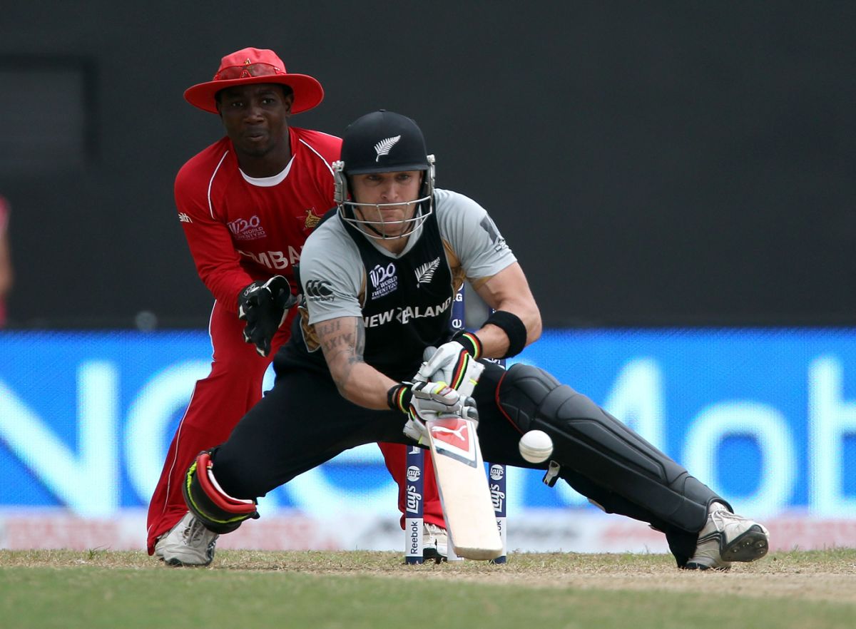 Brendon McCullum plays the scoop shot, as Tatenda Taibu watches