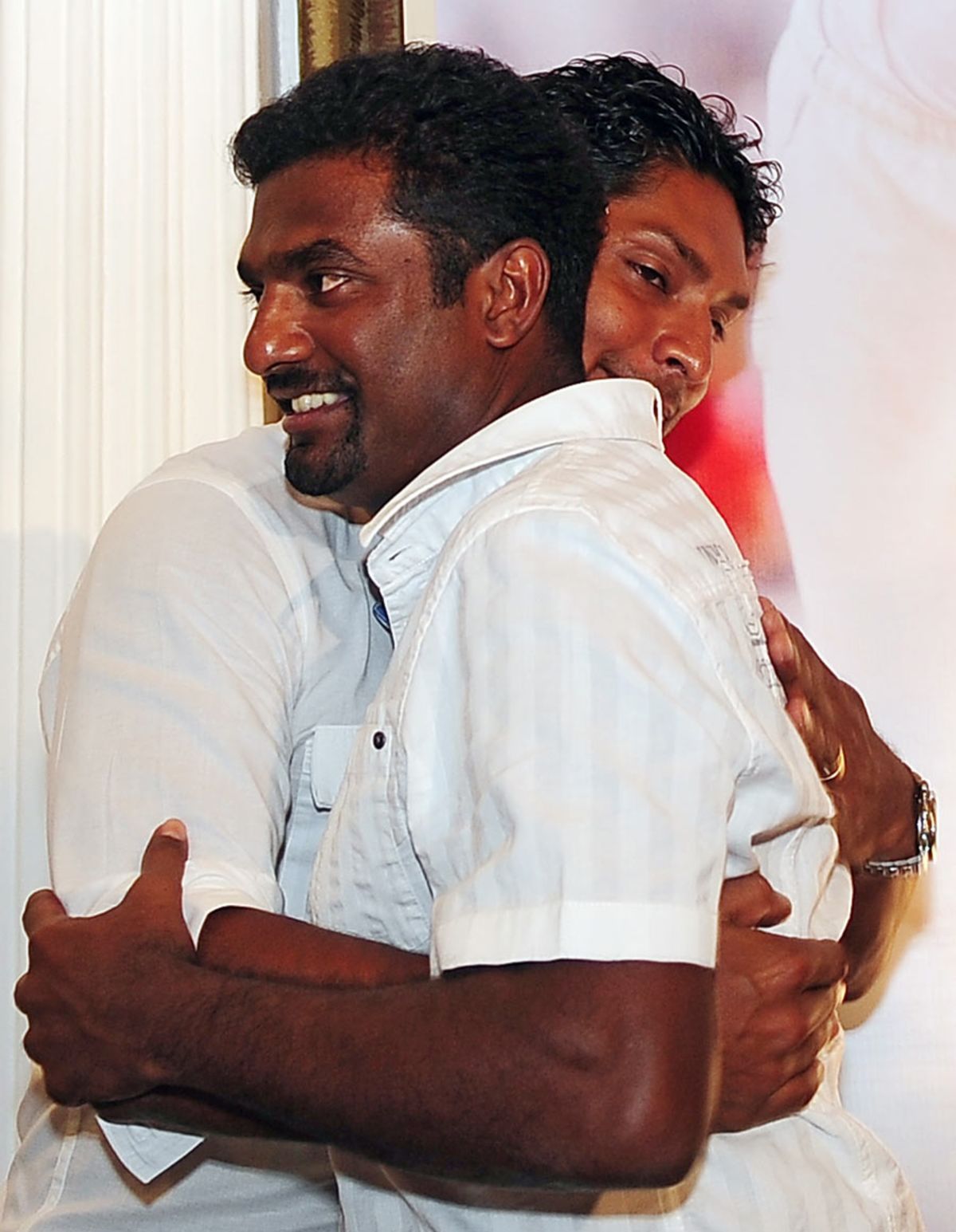 Muttiah Muralitharan is hugged by his captain Kumar Sangakkara, Colombo, July 8, 2010
