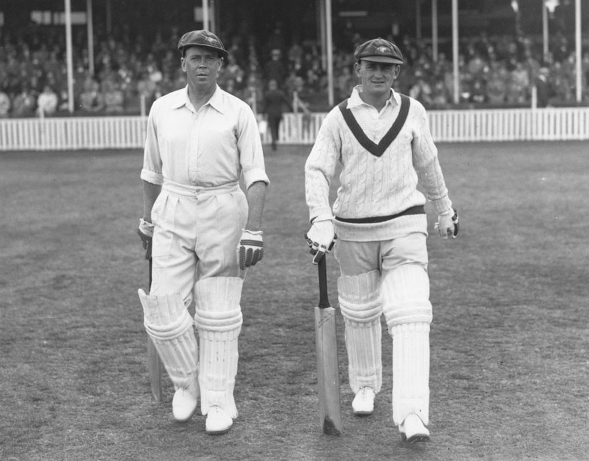 Don Bradman walks down Strand with a group of children following him ...