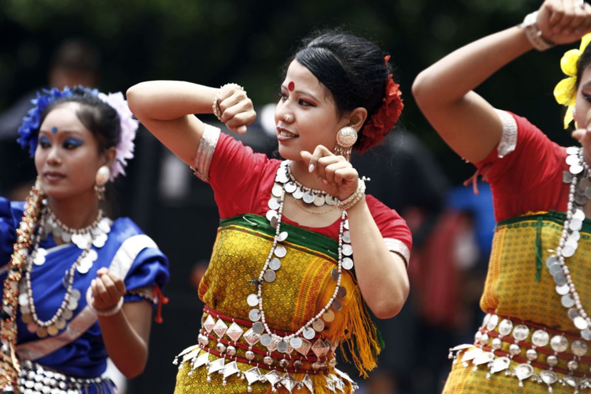 Bangladeshi tribal woman wearing traditional clothing dance at a rally 