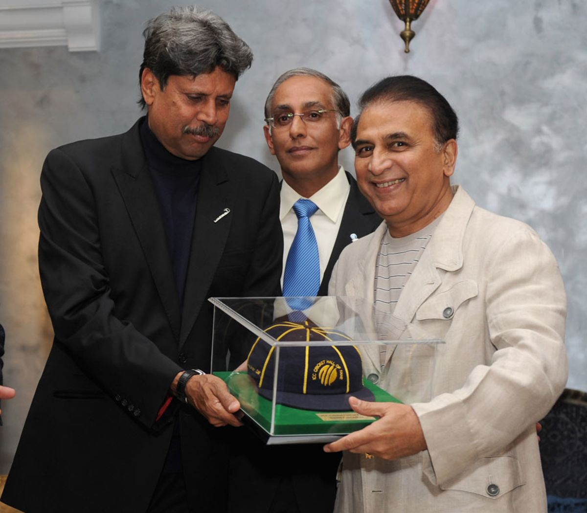 Kapil Dev hands the ICC Hall of Fame cap to Sunil Gavaskar, Dubai, February 8, 2012