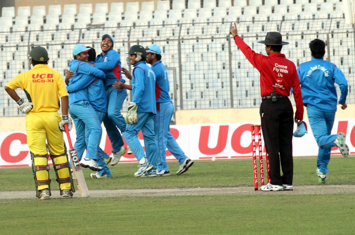 Prime Bank Cricket Club players celebrate a wicket