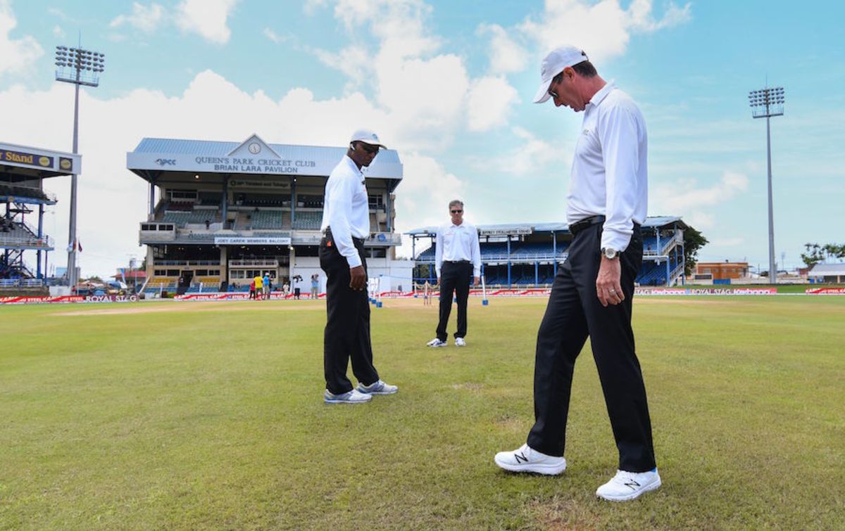 The umpires inspect the outfield at Queen's Park Oval, West Indies v India, 4th Test, Port of Spain, 2nd day, August 19, 2016