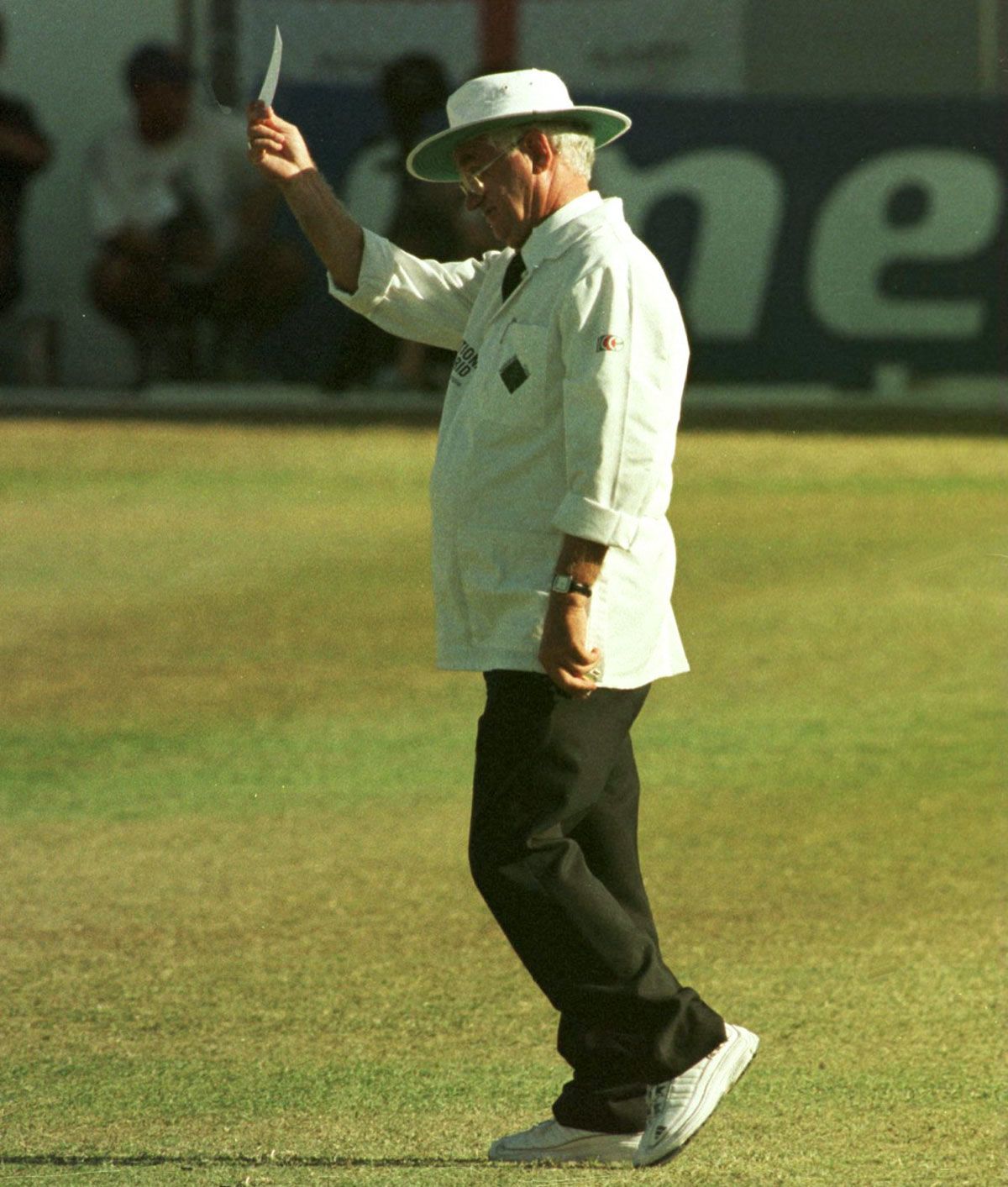 Umpire Cyril Mitchley jokingly batsman Philo Wallace a yellow card after having to leap out of the way to avoid getting injured by the batsman's shot, West Indies v England, 5th Test, 2nd day, March 13, 1998