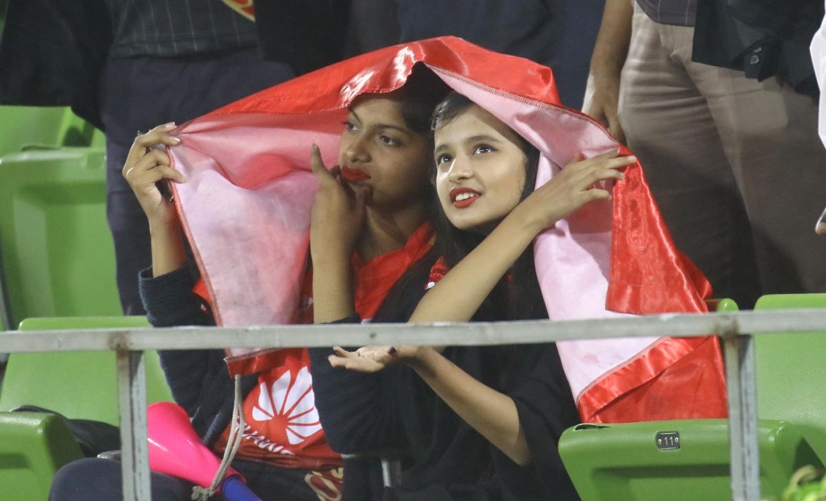 Two spectators take cover in Mirpur after rain stopped play, Comilla Victorians v Rangpur Riders, BPL 2017 qualifier 2, Dhaka, December 10, 2017