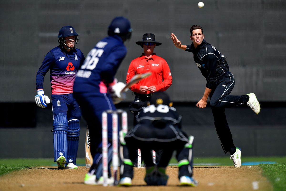 Shaun Haig, the reserve umpire, inspects the covers
