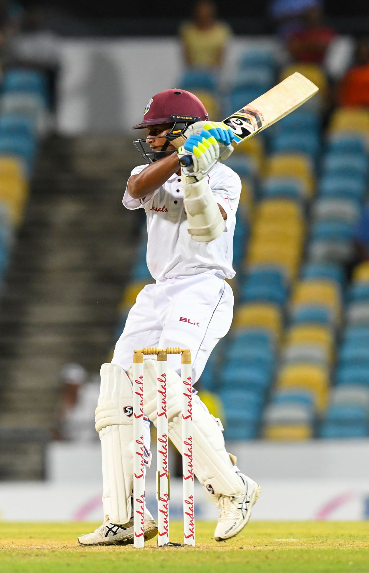 Three slips, gully, and floodlights surround the batsman at the