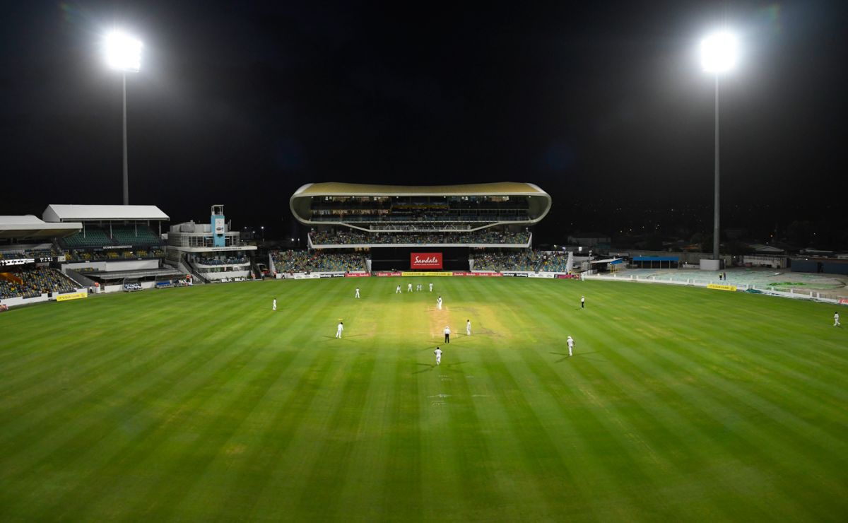 Three slips, gully, and floodlights surround the batsman at the