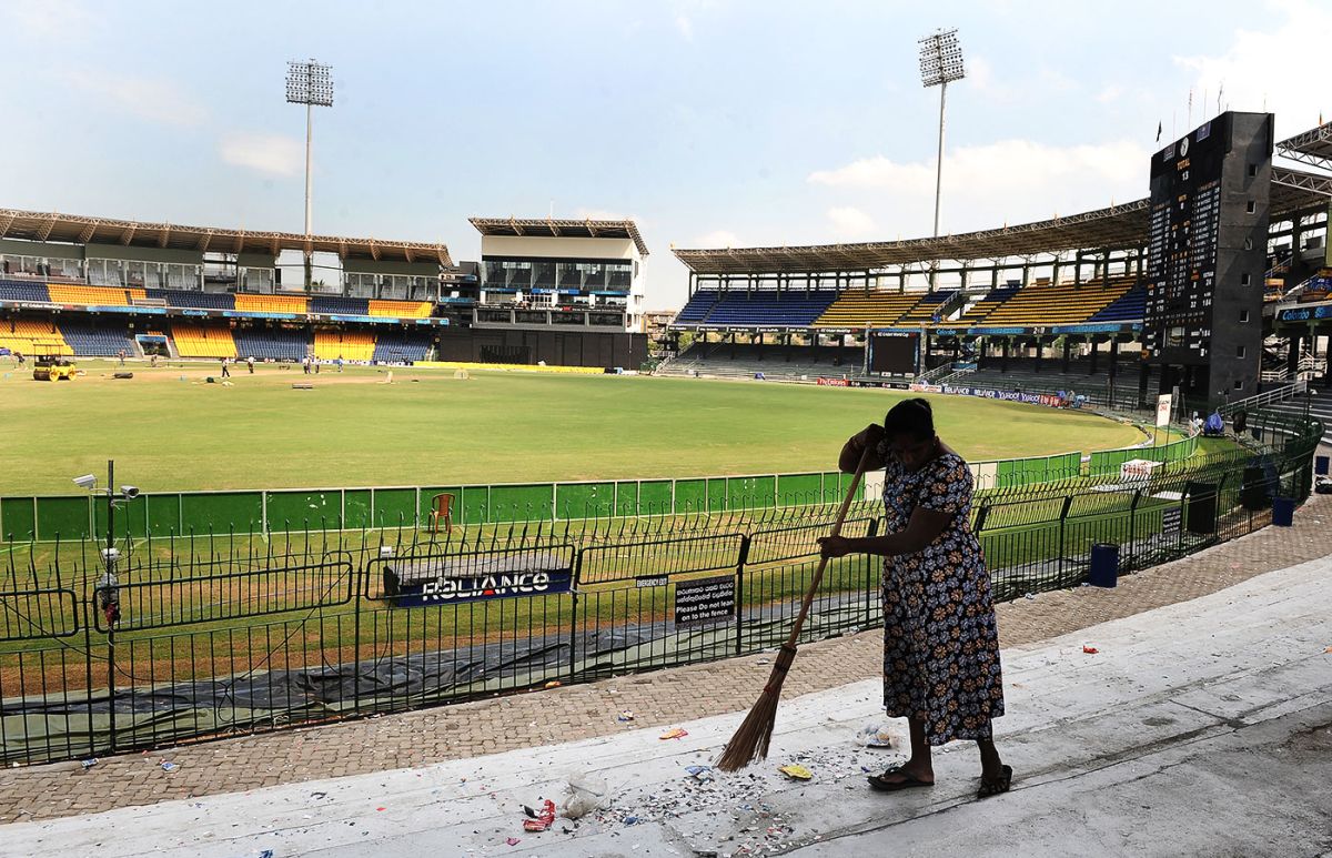 A groundstaff member sweeps the stands at the Premadasa, Colombo, March 4, 2011