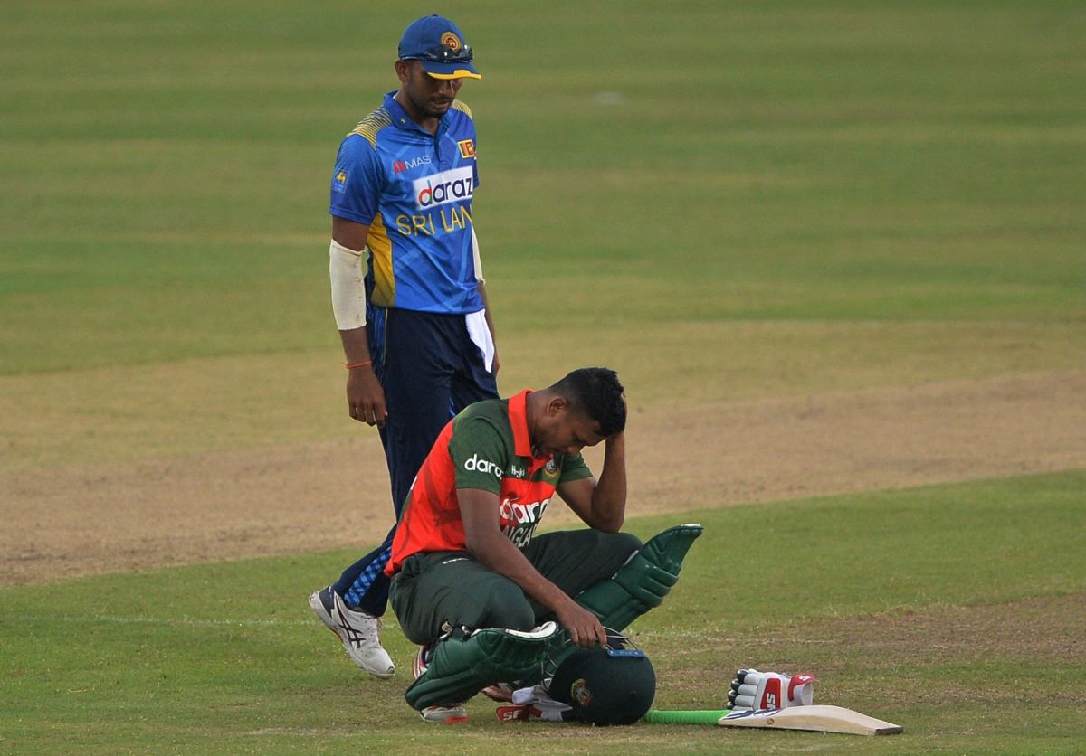 Mohammad Saifuddin reacts after being hit on the head while batting ESPNcricinfo