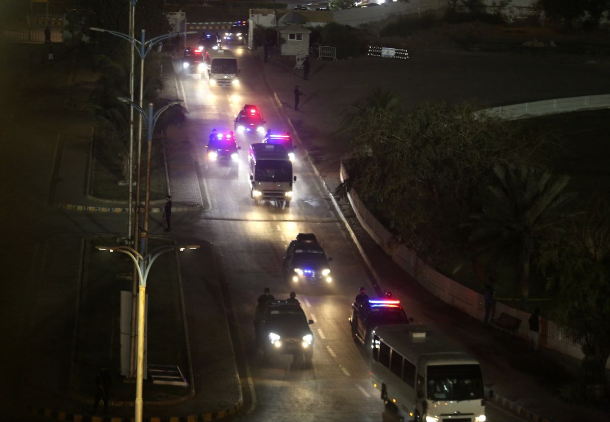 A police convoy escorts mini buses carrying West Indies and Pakistan