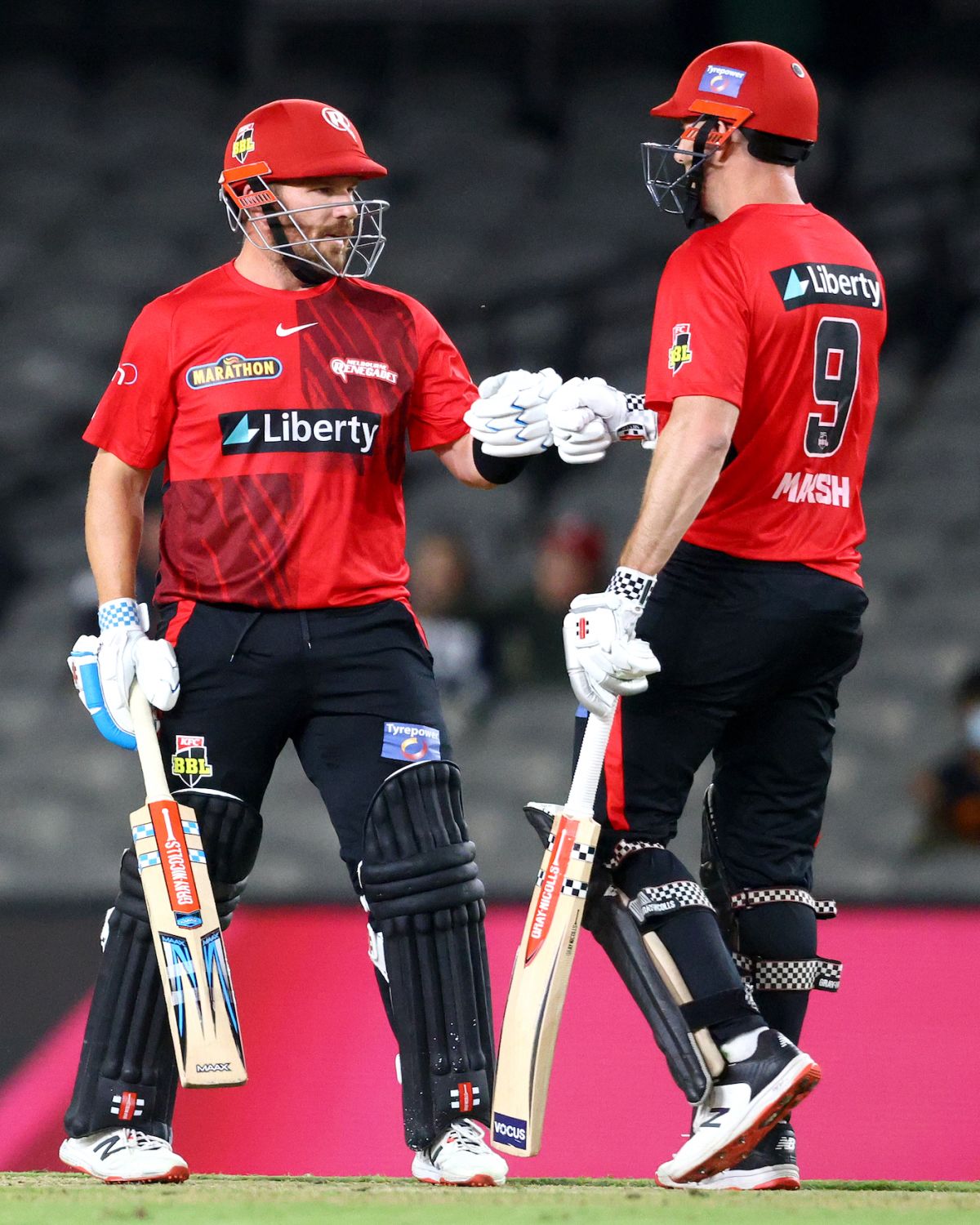 Aaron Finch and Shaun Marsh bump fists during their 101-run stand, Hobart Hurricanes vs Melbourne Renegades, BBL 2021-22, Melbourne, January 18, 2022