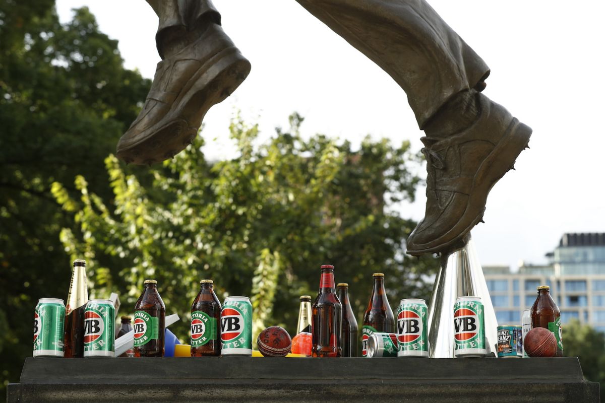 Cans and bottles of beer, and tins of baked beans at the foot of the