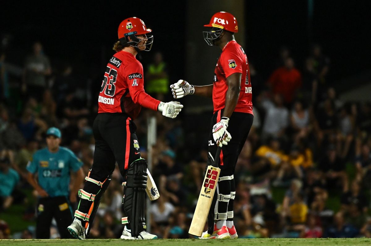 Nic Maddinson and Andre Russell bump fists in the middle ESPNcricinfo