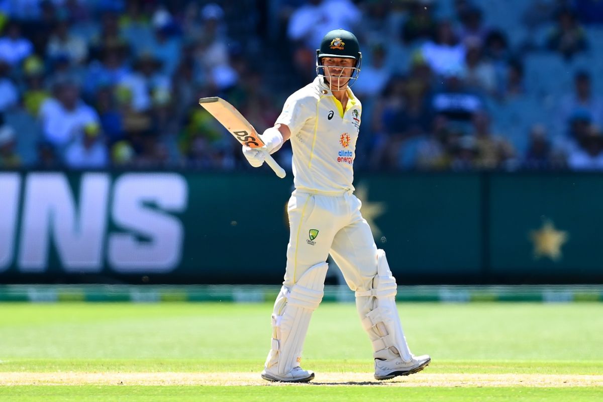 David Warner raises his bat after reaching his half-century in his ...