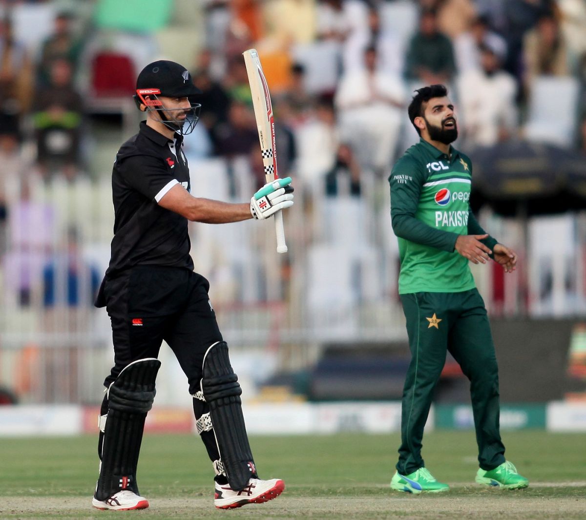 Daryl Mitchell Raises His Bat After Reaching 50 ESPNcricinfo
