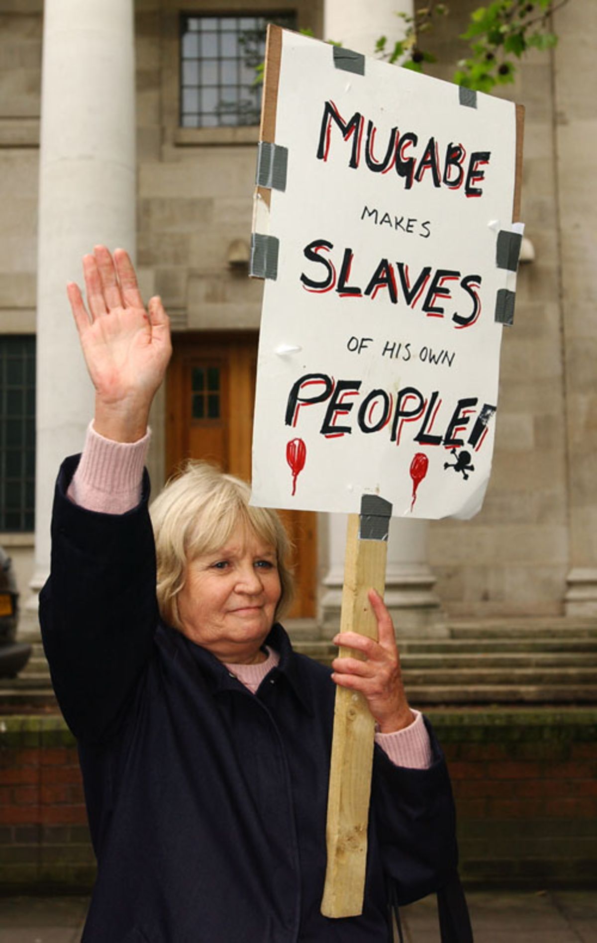 An anti mugabe protester outside lord s espncricinfo