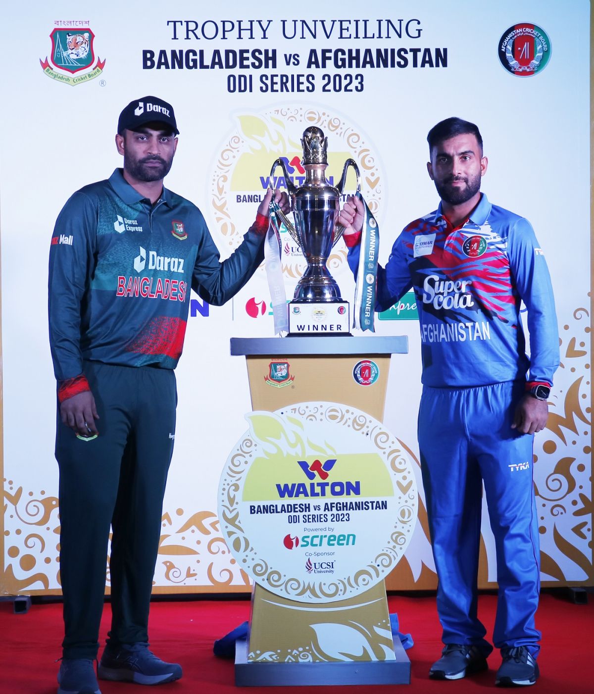 Tamim Iqbal and Hashmatullah Shahidi pose with the trophy 