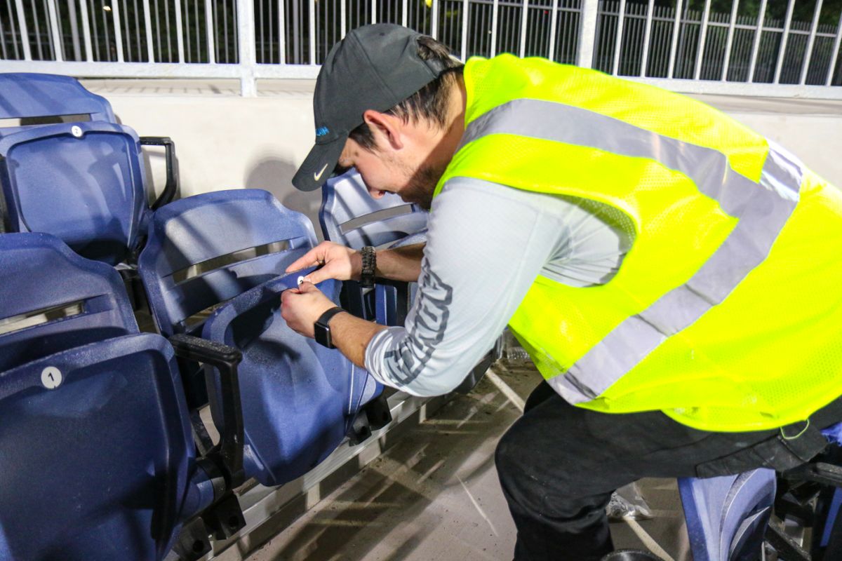 A Grand Prairie Stadium construction worker finishes putting number