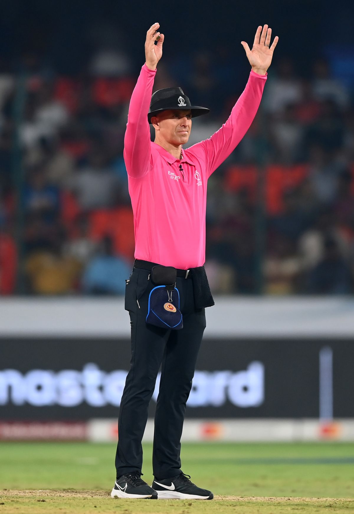 It's a six! Umpire Alex Wharf brings out the signal bowlers everywhere ...