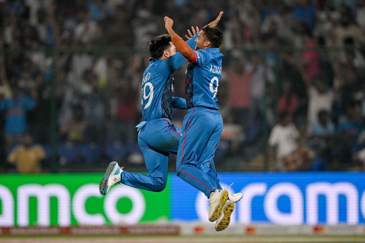 Rashid Khan and Azmatullah Omarzai reach for the stars while celebrating, England vs Afghanistan, Men's ODI World Cup 2023, Delhi, October 15, 2023