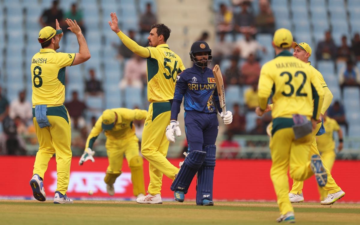 Dhananjaya de Silva walks back as Mitchell Starc celebrates ...