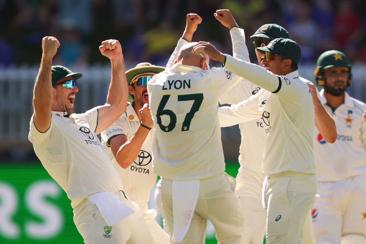 The Australians celebrate with Nathan Lyon after his 500th Test wicket ...