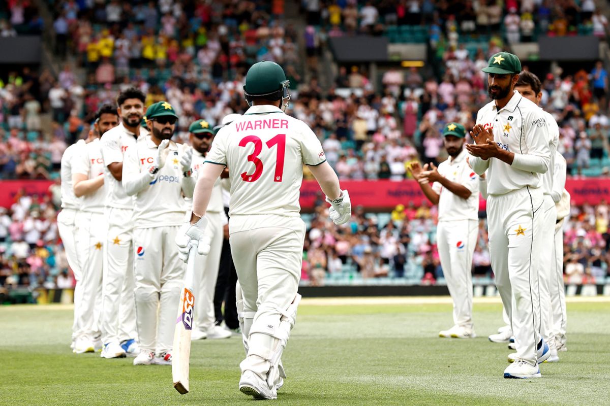 David Warner walks through the guard of honour