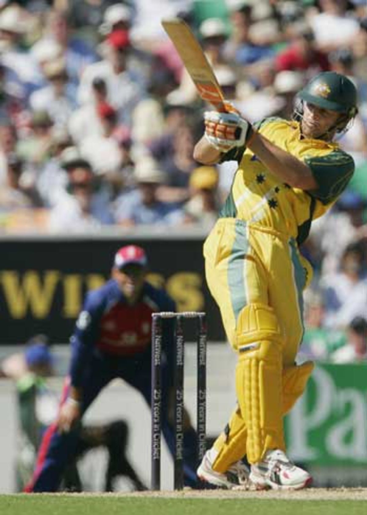 Adam Gilchrist launches a ball into the deep