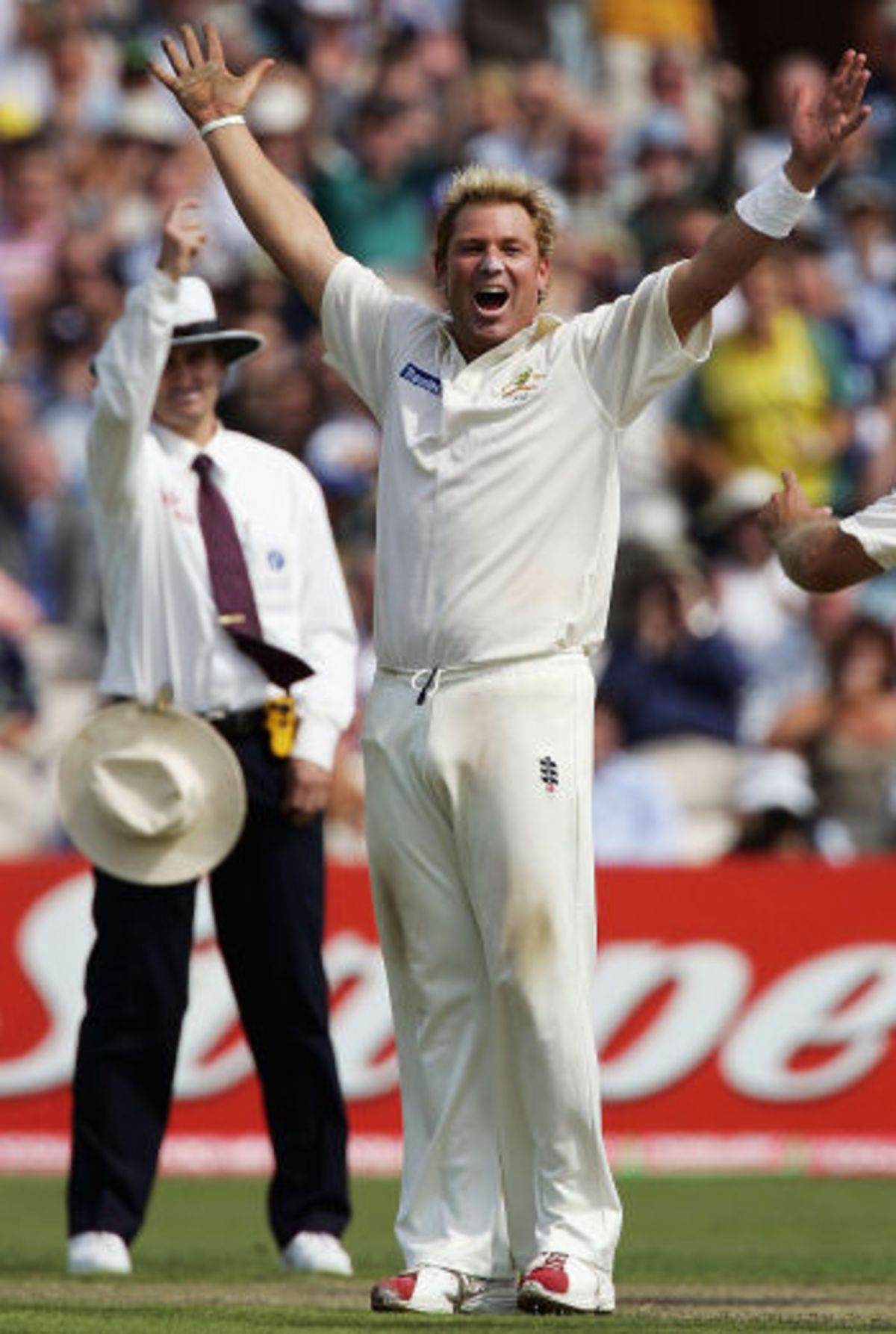 The Australians mob Shane Warne following his 600th Test wicket