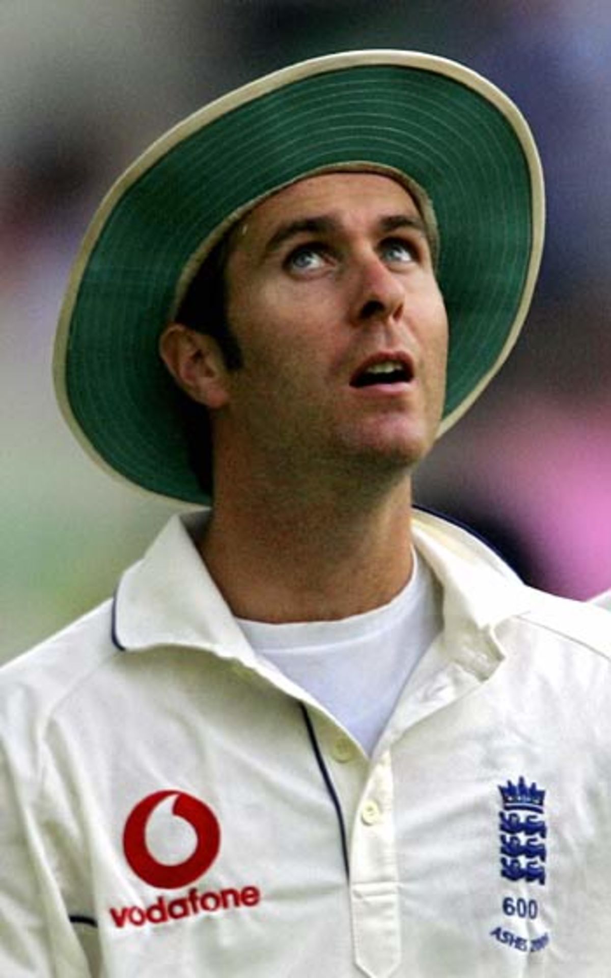 Michael Vaughan looks skywards as the rain approaches