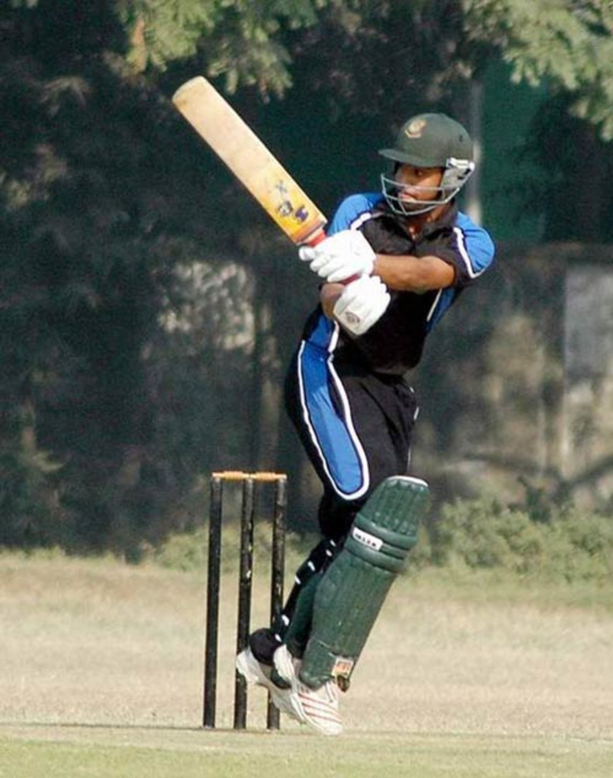 Old DOHS' opening batsman Tamim Iqbal plays one on the on-side 